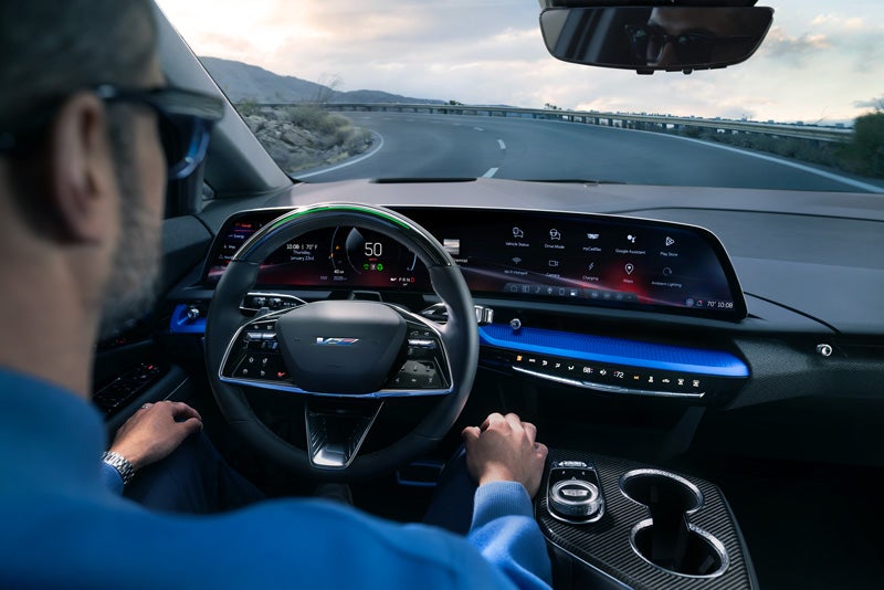 Front View of the 2026 OPTIQ-V Driving Through the Dusk Utilizing its Headlights | Classic Cadillac of Galveston in GALVESTON TX